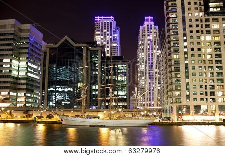 LONDON, CANARY WHARF UK - APRIL 4, 2014  Canary Wharf dock and antique yacht