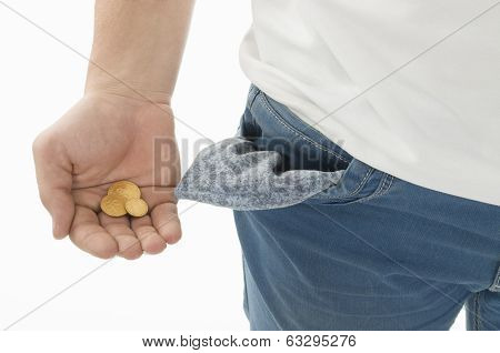 Man in blue jeans while shows his empty pockets