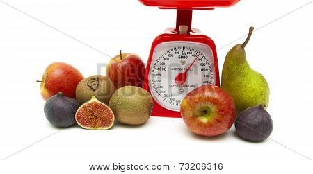 Fresh Fruit And Kitchen Scale On White Background