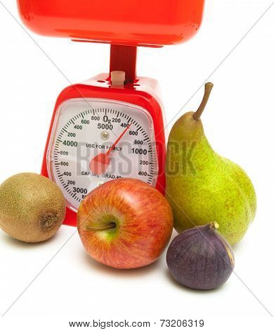 Ripe Fruit And Kitchen Scales Close Up On A White Background