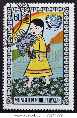 MONGOLIA - CIRCA 1977: stamp printed in Mongolia shows Girl cwith bouquet of flowers circa 1977