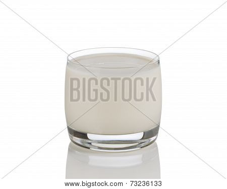 Full Glass Of Fresh Milk On White With Reflection