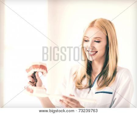 smiling female doctor with big jaws and toothbrush..