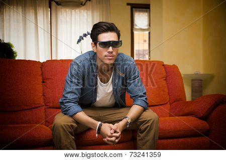 Young Man In 3D Glasses Sitting Watching Television