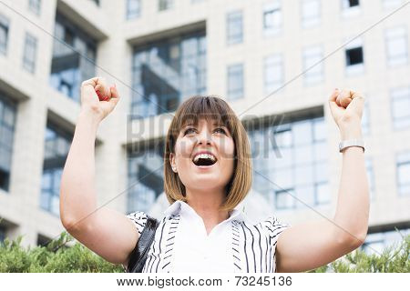 Successful Businesswoman With Both Hands Up