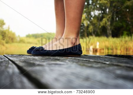 Girl wearing beautiful fashion shoes in nature