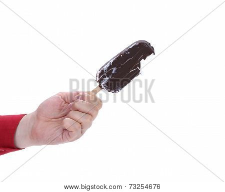 Hand holds chocolate ice cream.