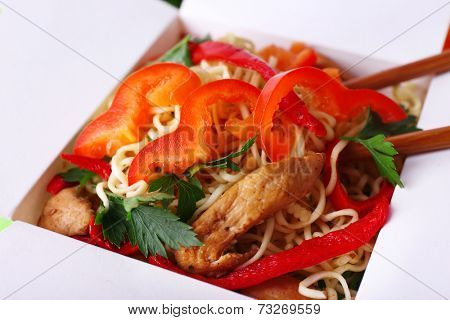 Chinese noodles in takeaway box closeup