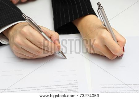 Man And Woman Signing Document Or Prenup