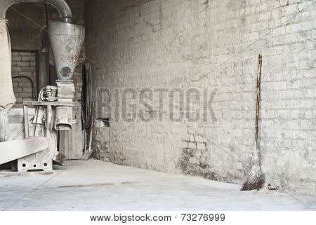 electric corn mill and wooden broom