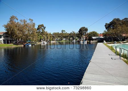 Private Lake with homes and boats in Lake Forest California. Lake Forest has many Private Lakes with limited access to the general public, making it an ideal and serene location to live life. 