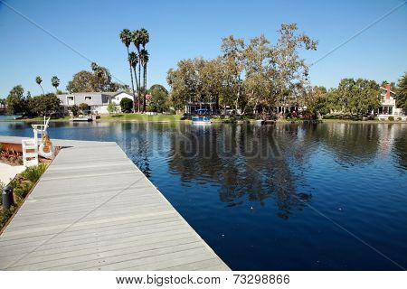 Private Lake with homes and boats in Lake Forest California. Lake Forest has many Private Lakes with limited access to the general public, making it an ideal and serene location to live life. 