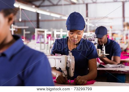african textile factory machinist working in production line