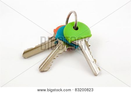 Three House Keys with coloured caps