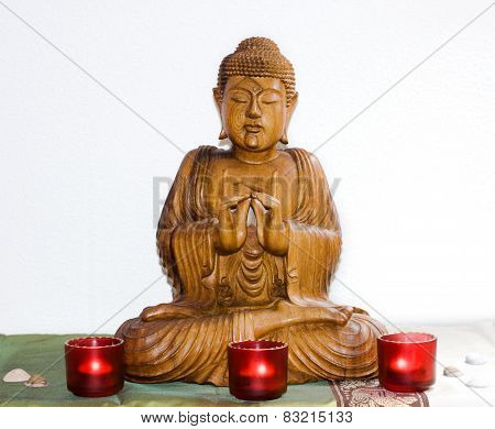wooden carving of Lord Buddha welcoming