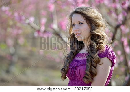 young beautiful woman portrait on field in summer