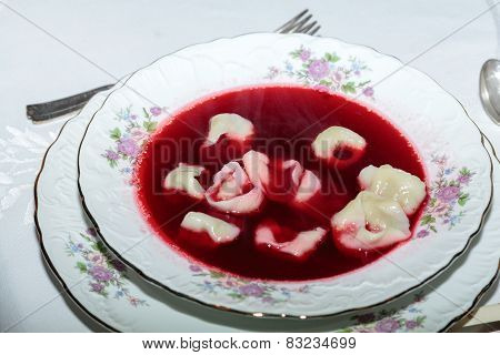 red borsch with mushroom filled kind of dumplings