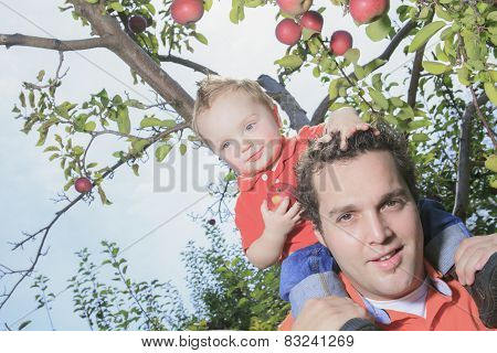 Father giving piggyback ride to his son