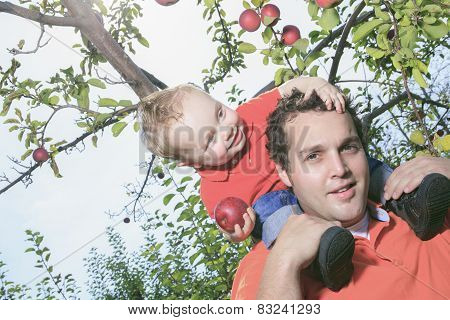 Father giving piggyback ride to his son