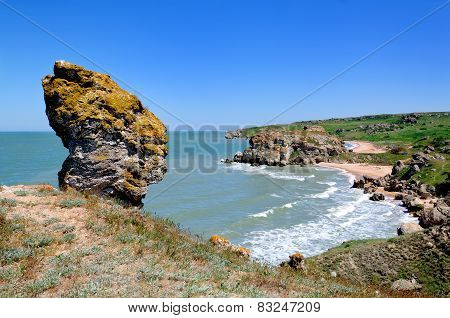 Large Stone In  Form Of  Head On  Beach