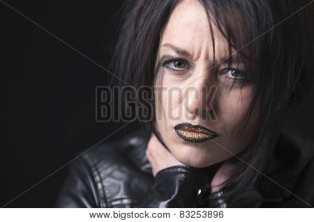 A gothic woman over a dark background,