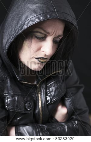 A gothic woman over a dark background,