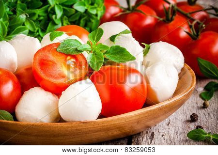 Mozzarella, Organic Cherry Tomatoes And Fresh Basil Closeup