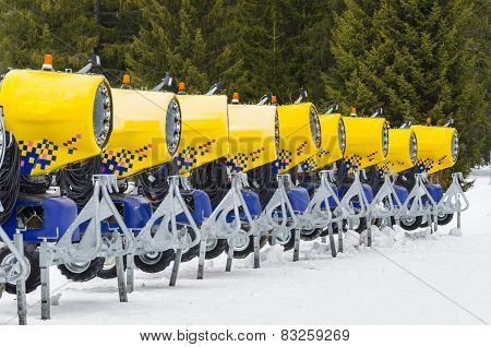 modern yellow cannons in raw for snow making