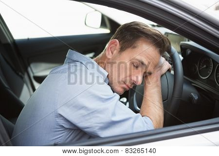 Drunk man slumped on steering wheel in his car