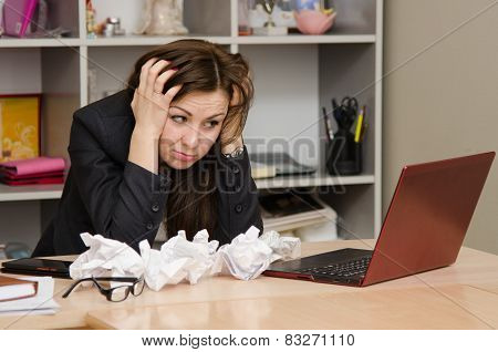 The Girl At Computer With A Bunch Of Crumpled Sheets Paper