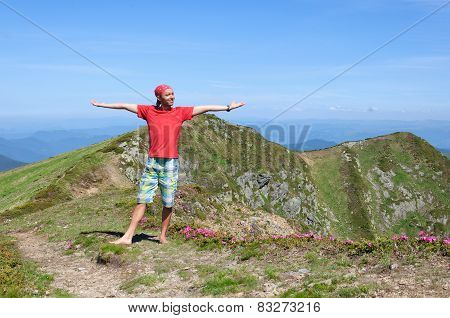 Trekker Walking Flowers Field In Mountain