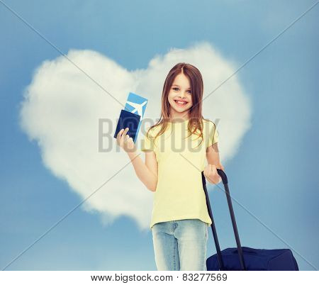 tourism, vacation, childhood and transportation concept - smiling little girl with travel bag, ticket and passport over airport background