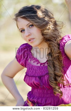 young beautiful woman portrait on field in summer