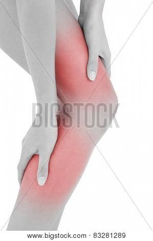 Closeup mid section of a fit young woman with leg pain over white background