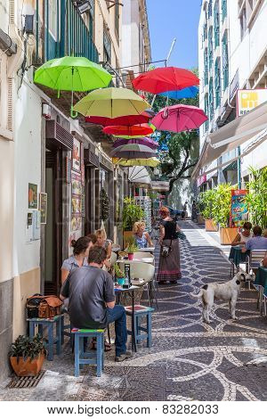 Tourists Sitting At The Terrace Of A Small Restarant In Funchal, Madeira Island