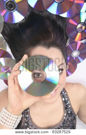A young girl with DVDs record lay on the ground