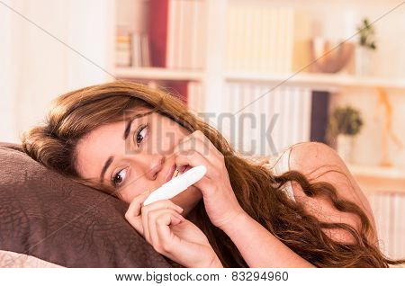 nervous young girl holding pregnancy test