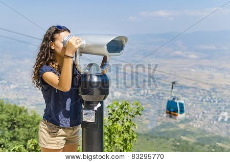 Girl looking through coin operated binoculars on Vodno mountain