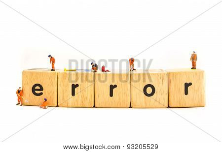 Idea Concept Image Of Mini Figure Dolls Engineer Fixing On Wooden Toy Letter