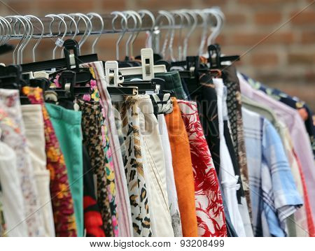 Vintage Clothes Hanging In The Open Air Market Of Used Things