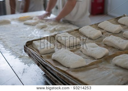 Baker And Tray Of Fresh Ciabatta Bread Buns
