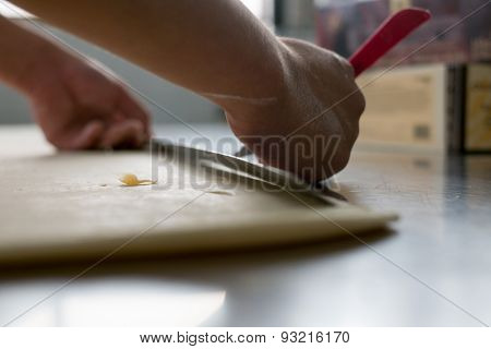 Freshly Made Croissant Dough Being Hand Cut