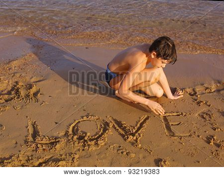 Preteen Handsome Sun Tanned Boy On The Red Sea Beach Whrite Love On The Sand