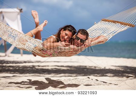Romantic Couple Relaxing In Beach Hammock