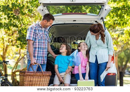 Happy family getting ready for road trip on a sunny day