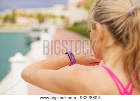 Woman looking at her smartwatch during workout