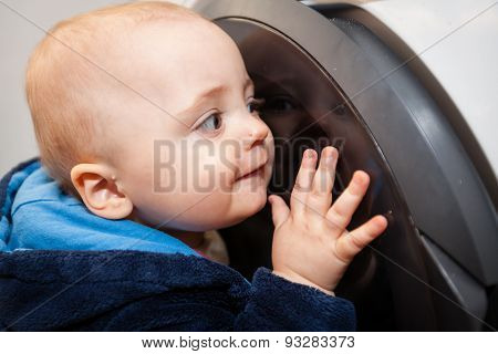 Portrait of a cute little baby boy looking with fascination inside the washing machine
** Note: Soft Focus at 100%, best at smaller sizes