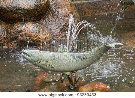 Old bathing house building sculpture fish detail