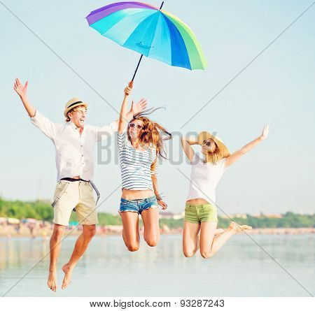Group of happy young people having fun on the beach