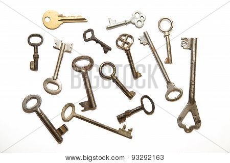 Many Old Keys To The Safe On A White Background